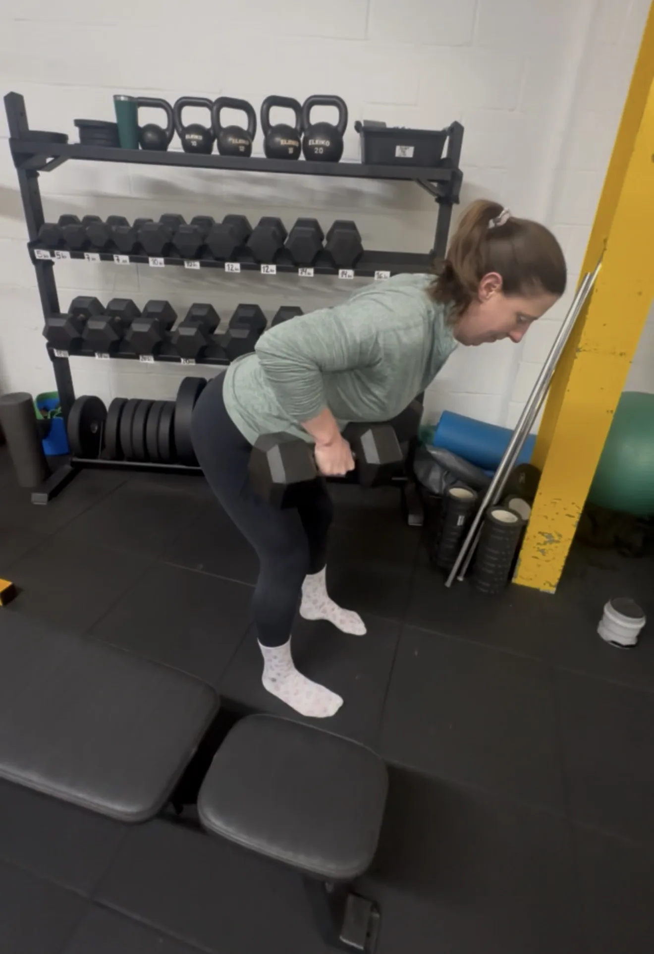 A client training with dumbbells in the gym