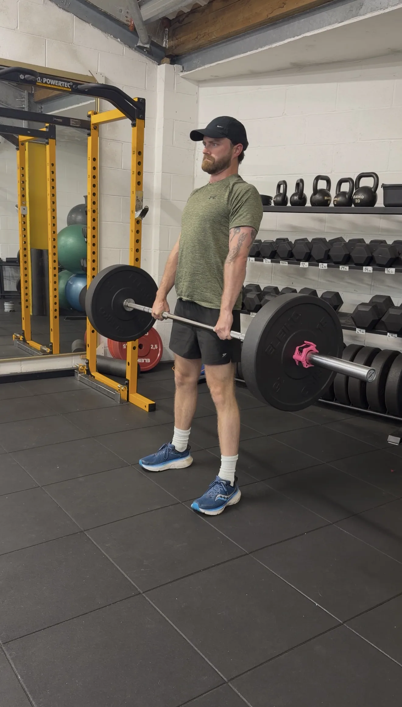 Client practising a coached strength movement in the studio