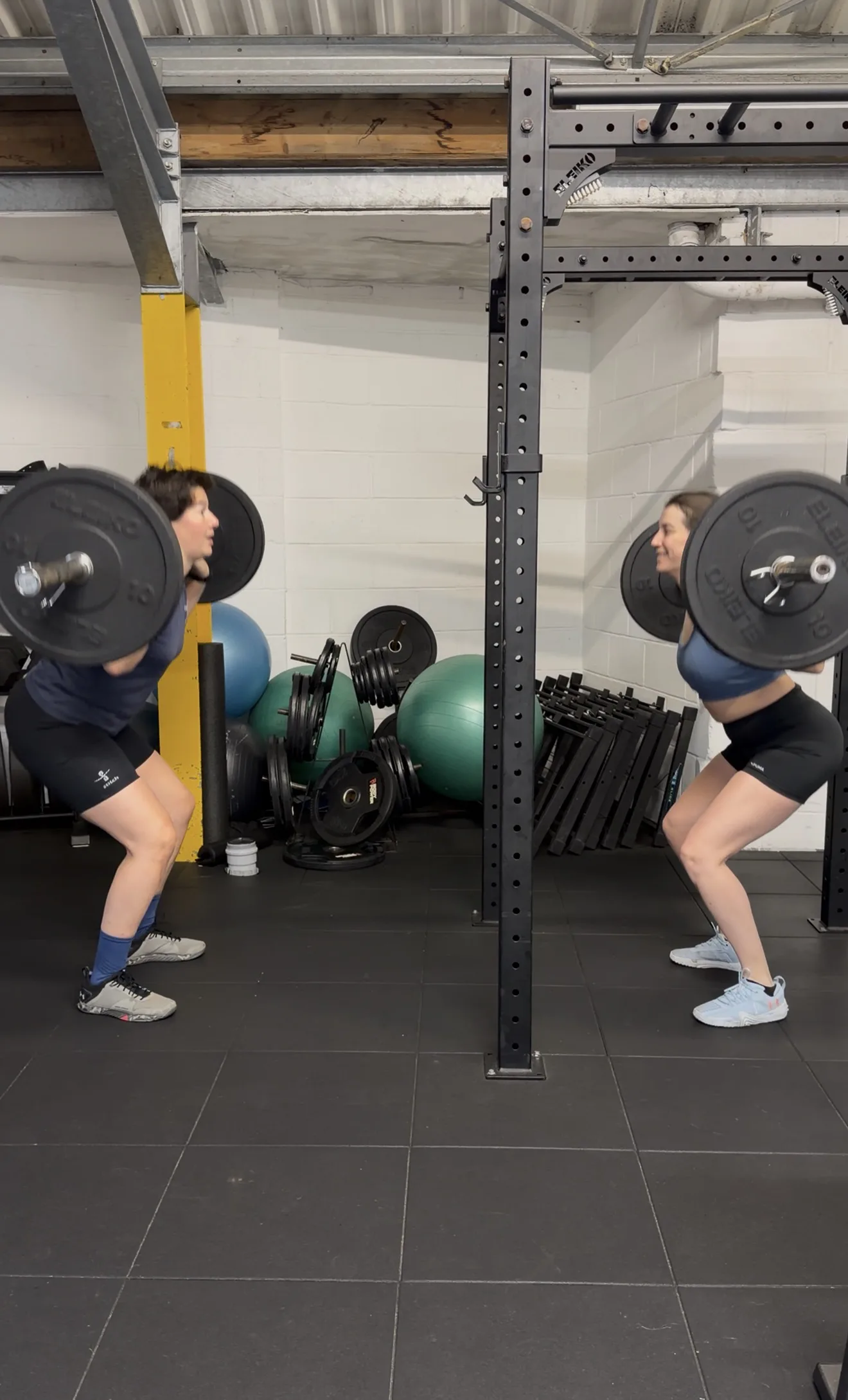 Two clients strength training together in a semi-private session